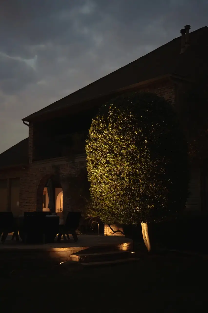 Blue-hour landscape and architectural lighting on a Texas home with a columned porch