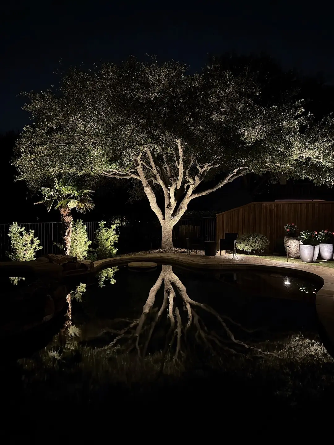 Nighttime landscape lighting on a North Texas home by K Legacy Lighting