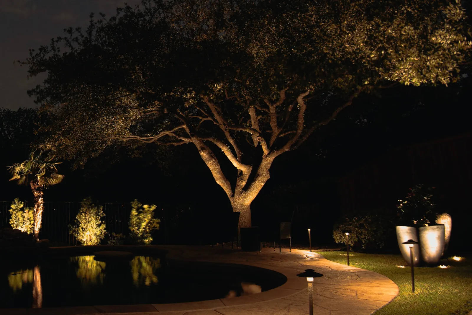 Blue-hour landscape lighting on a historic Texas home with columned porch