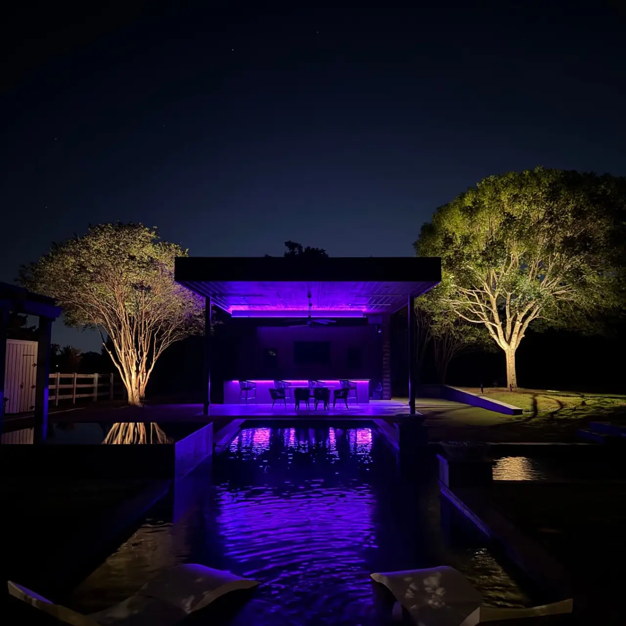 Backyard pavilion and pool after lighting installation