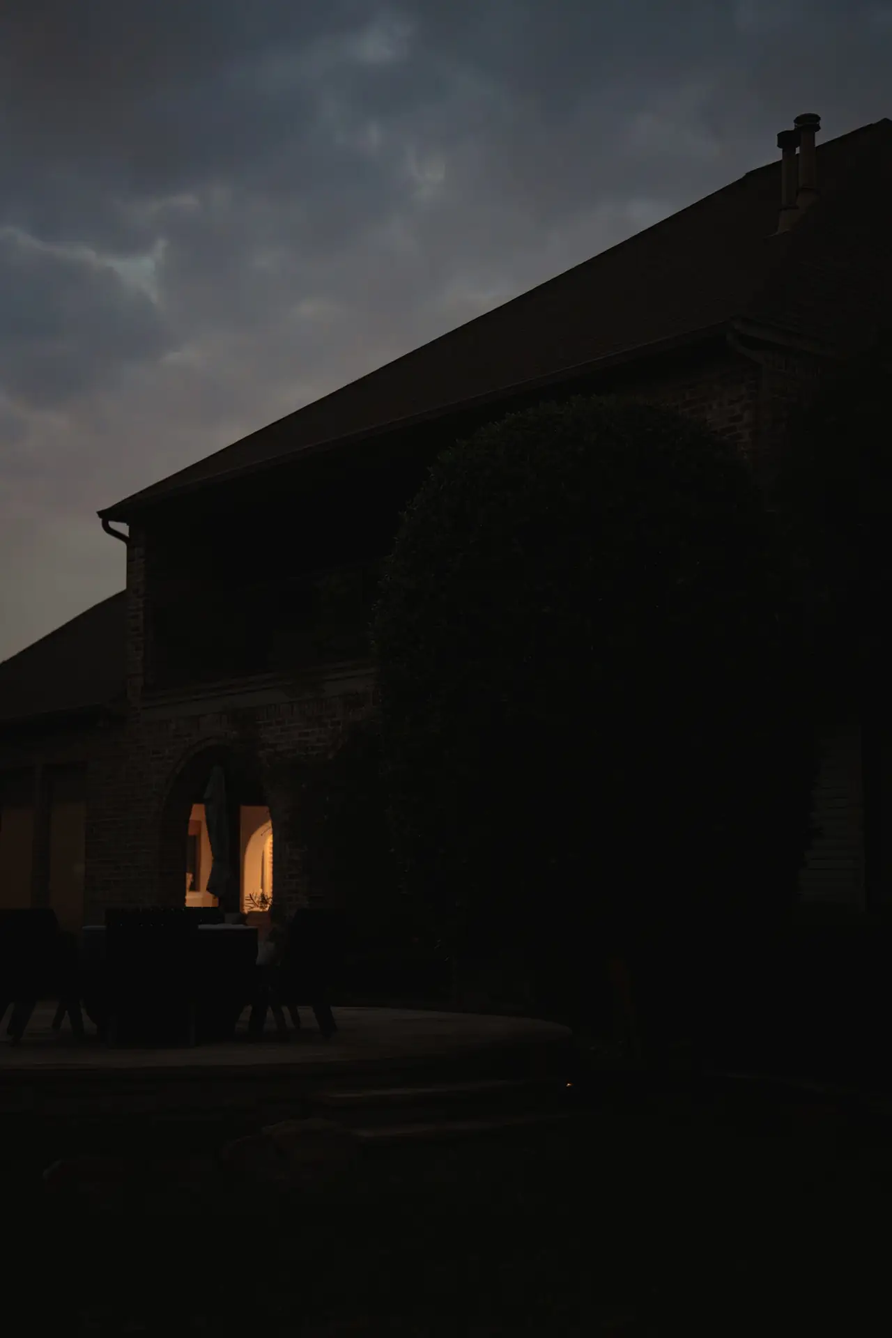 Brick home elevation in North Texas before lighting installation